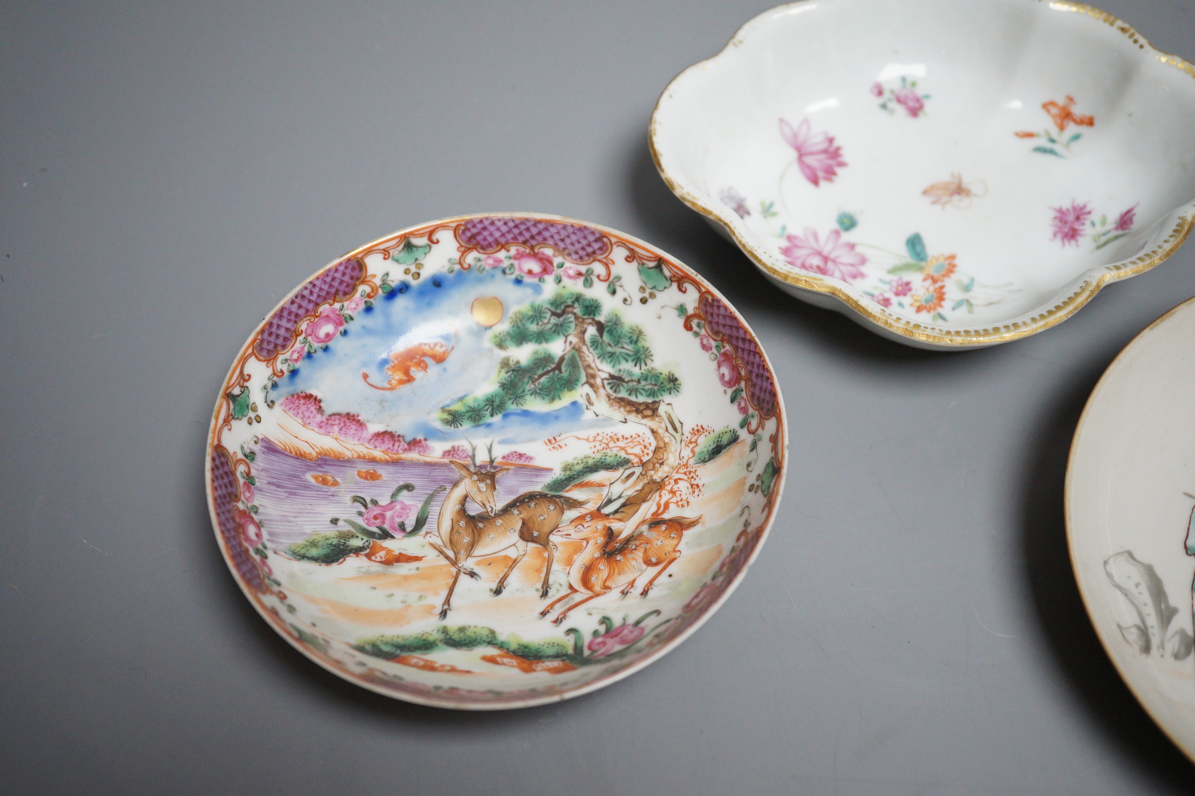 Two 18th century Chinese export saucers and two other later dishes, largest 13cm diameter
